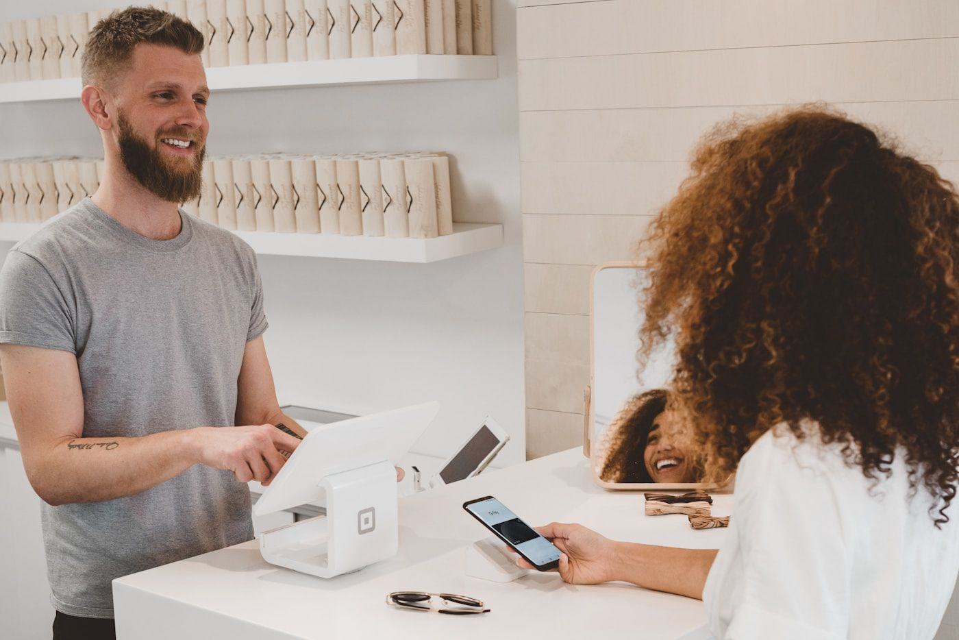 A small business owner serving a customer at the counter